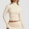 Auri Modal Ruched Backless Turtleneck Μπλούζα σε χρώμα ιβουάρ Auri Modal Ruched Backless Turtleneck Μπλούζα σε χρώμα ιβουάρ